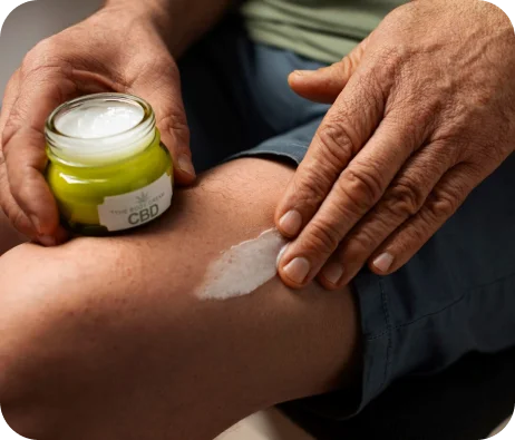 Applying CBD cream in the legs