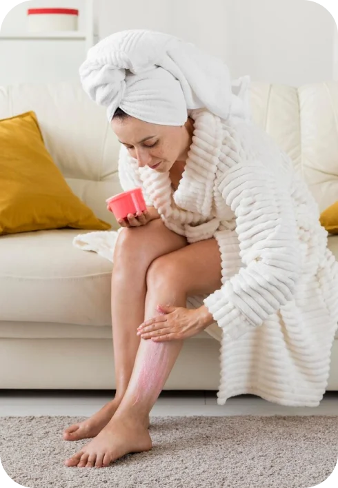 Applying cream to legs